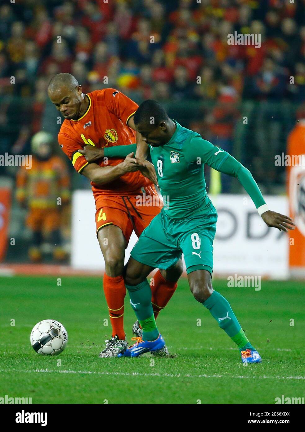 Belgium's Vincent Kompany (L) and Ivory Coast's Salomon Kalou battle for  the ball during their international friendly soccer match at King Baudouin  Stadium in Brussels March 5, 2014. REUTERS/Yves Herman (BELGIUM -