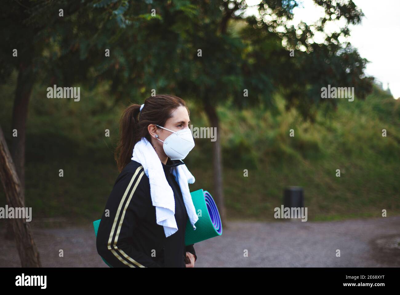 Girl in the park while wearing a facemask - new normal amidst COVID19 pandemic Stock Photo