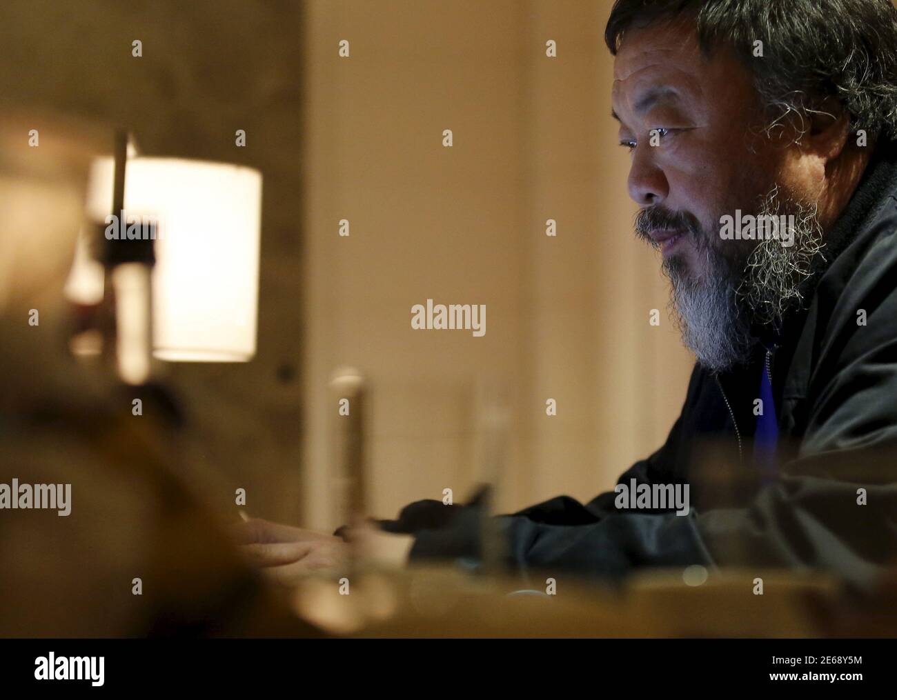 Dissident Chinese artist Ai Weiwei uses his laptop after an interview with Reuters at the hotel he is staying at in Beijing, March 24, 2015. Amnesty International has given its top 2015 human rights award to both Chinese dissident artist Ai Weiwei, a fierce critic of Beijing who has been banned from leaving China after an 81-day detention in 2011, and U.S. folksinger Joan Baez.   REUTERS/Kim Kyung-Hoon Stock Photo