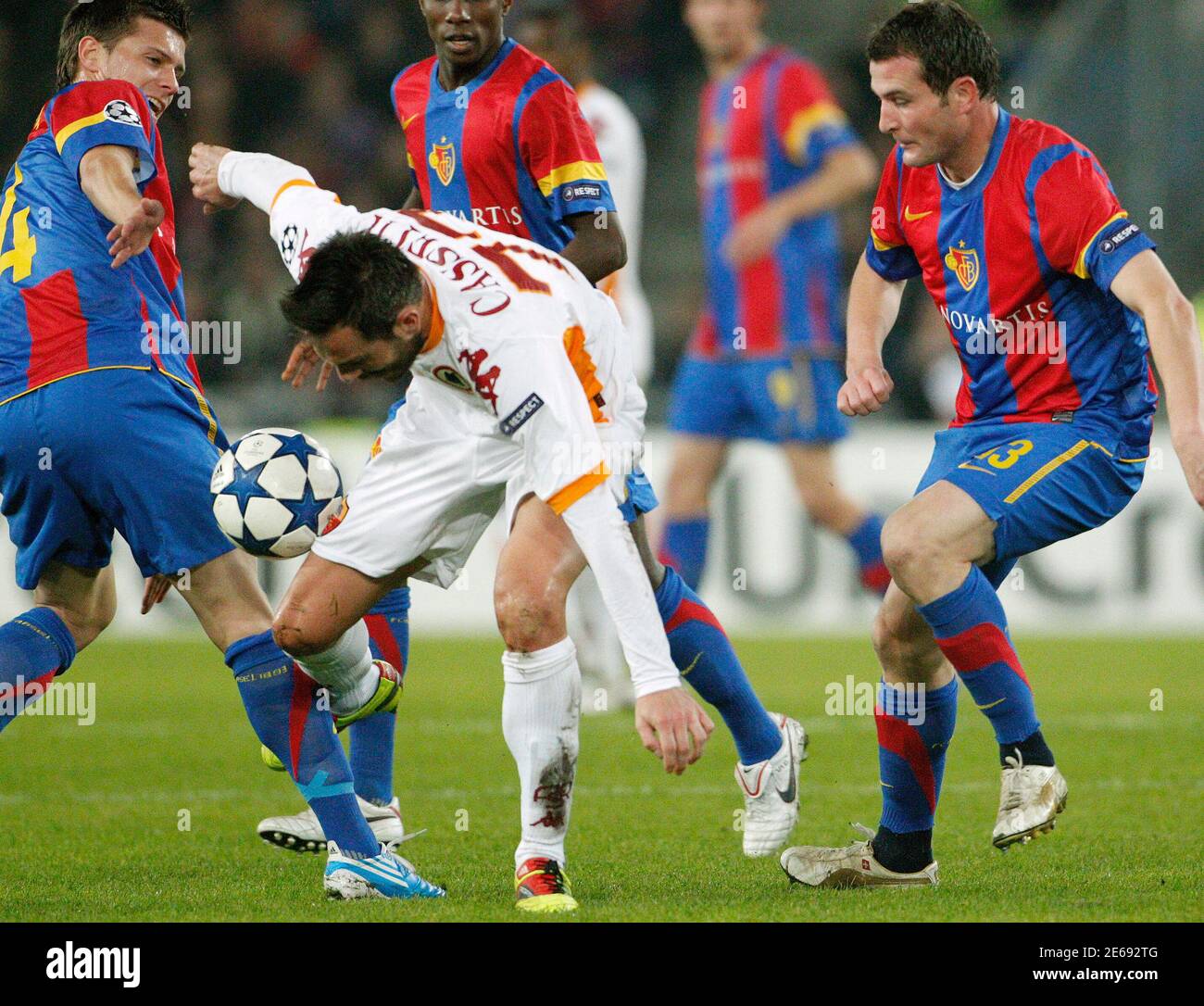 FC Basel's (FCB) Valentin Stocker (L) and Alexander Frei (R) challenge AS  Roma's Marco Cassetti during their Champions League Group E soccer match in  Basel November 3, 2010. REUTERS/Christian Hartmann (SWITZERLAND -