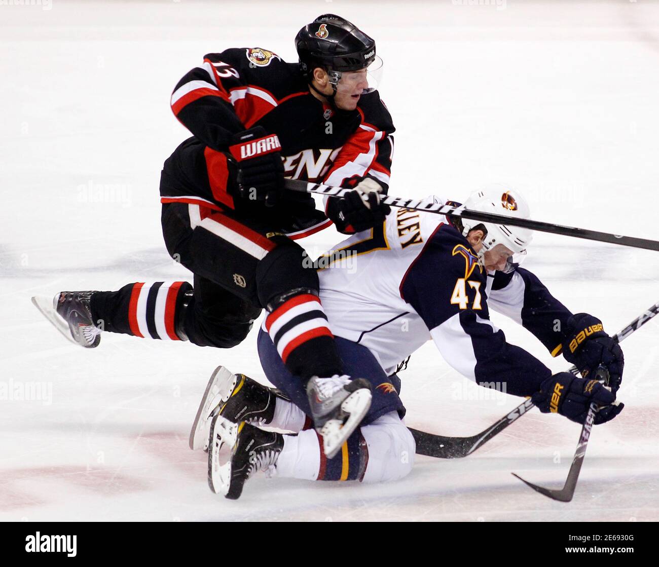 Ottawa Senators' Peter Regin (L) collides with Atlanta Thrashers' Rich Peverley during the first period of their NHL hockey game in Ottawa November 9, 2010.     REUTERS/Blair Gable     (CANADA - Tags: SPORT ICE HOCKEY) Stock Photo