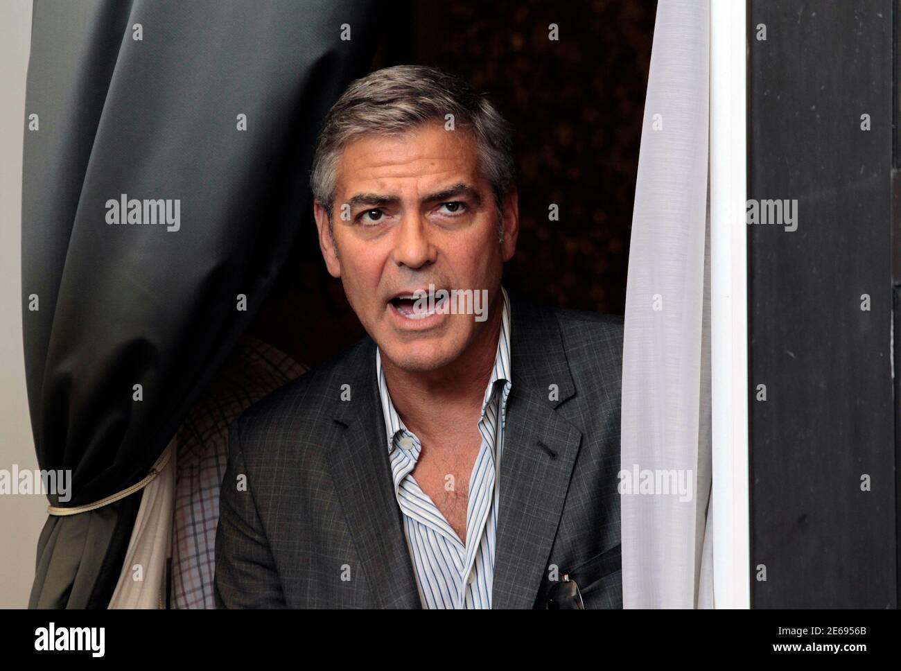 George Clooney reacts as he arrives for a photocall of his film 'The Ides of March' at the 68th Venice Film Festival in Venice August 31, 2011. REUTERS/Alessandro Bianchi  (ITALY - Tags: ENTERTAINMENT) Stock Photo