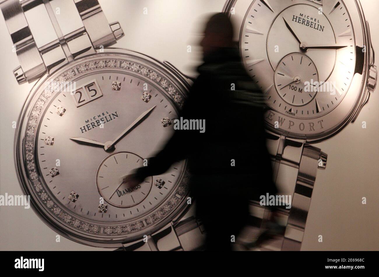 A visitor makes his way past Michel Herbelin showcase at Baselworld fair in  Basel, March 7, 2012. The world's leading watch and jewellery show  Baselworld is to be held in Basel from