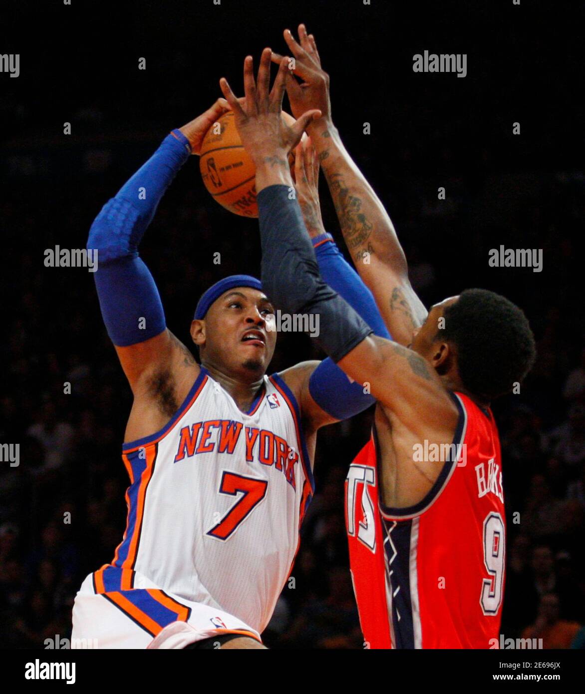 New York Knicks Carmelo Anthony (L) tries to shoot over New Jersey Nets  Marshon Brooks during their NBA basketball game at Madison Square Garden in New  York, February 20, 2012. REUTERS/Eduardo Munoz (