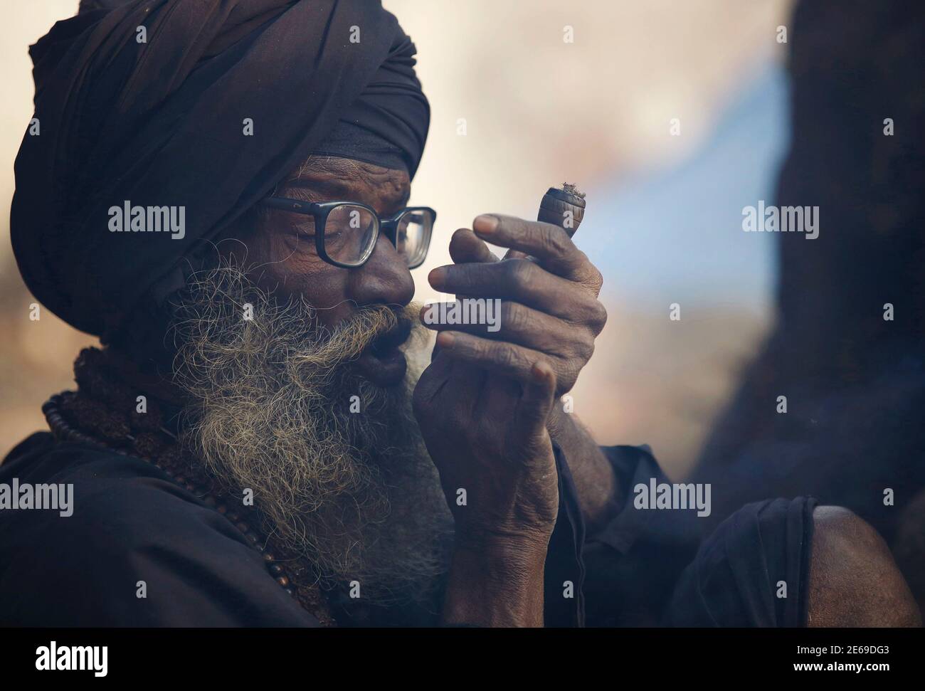 Hindu Holy Man Or Sadhu Smokes Marijuana With A Chillum On The Premises Of Pashupatinath Temple In Kathmandu February 16 2015 Hindu Holy Men From Nepal And India Come To This Temple