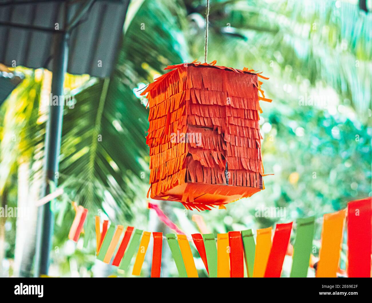 Square shaped children party mexican orange pinata hanging outdoor used for  fun in posadas and birthday holiday, colourful yellow red green decoration  Stock Photo - Alamy