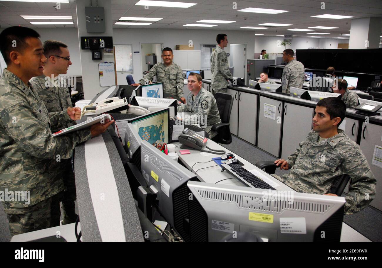 Personnel work at the Air Force Space Command Network Operations & Security Center at Peterson Air Force Base in Colorado Springs, Colorado July 20, 2010. U.S. national security planners are proposing that the 21st century's critical infrastructure -- power grids, communications, water utilities, financial networks -- be similarly shielded from cyber marauders and other foes. The ramparts would be virtual, their perimeters policed by the Pentagon and backed by digital weapons capable of circling the globe in milliseconds to knock out targets.  To match Special Report  USA-CYBERWAR/          RE Stock Photo