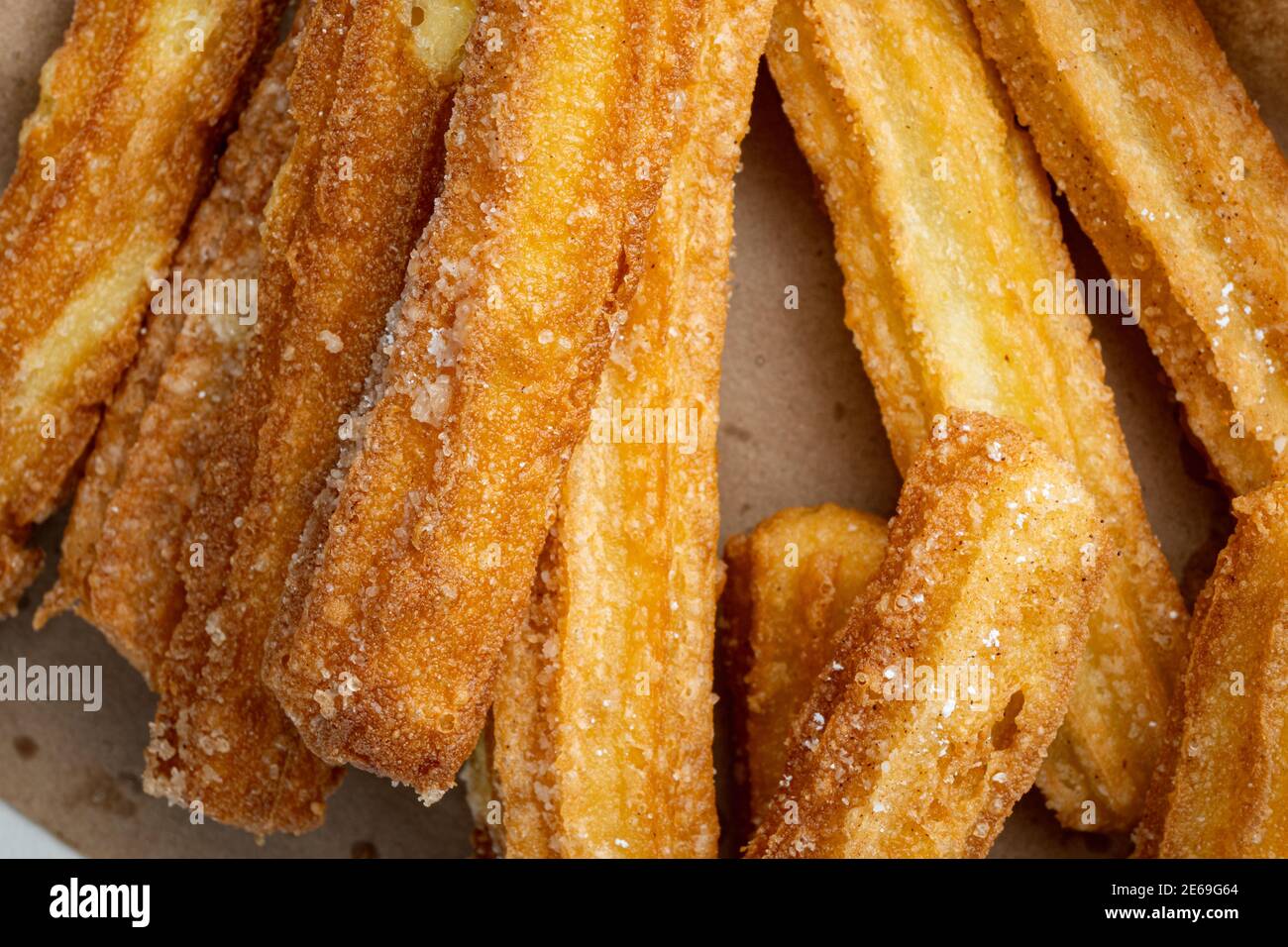 Traditional churros sticks with cinnamon and sugar powder, top view flat lay Stock Photo