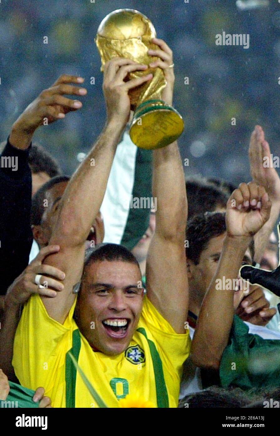 Brazil's Ronaldo holds up the trophy after beating Germany in the World Cup  final in Yokohama, in this June 30, 2002, file photo. Ronaldo announced his  retirement on February 14, 2011, ending