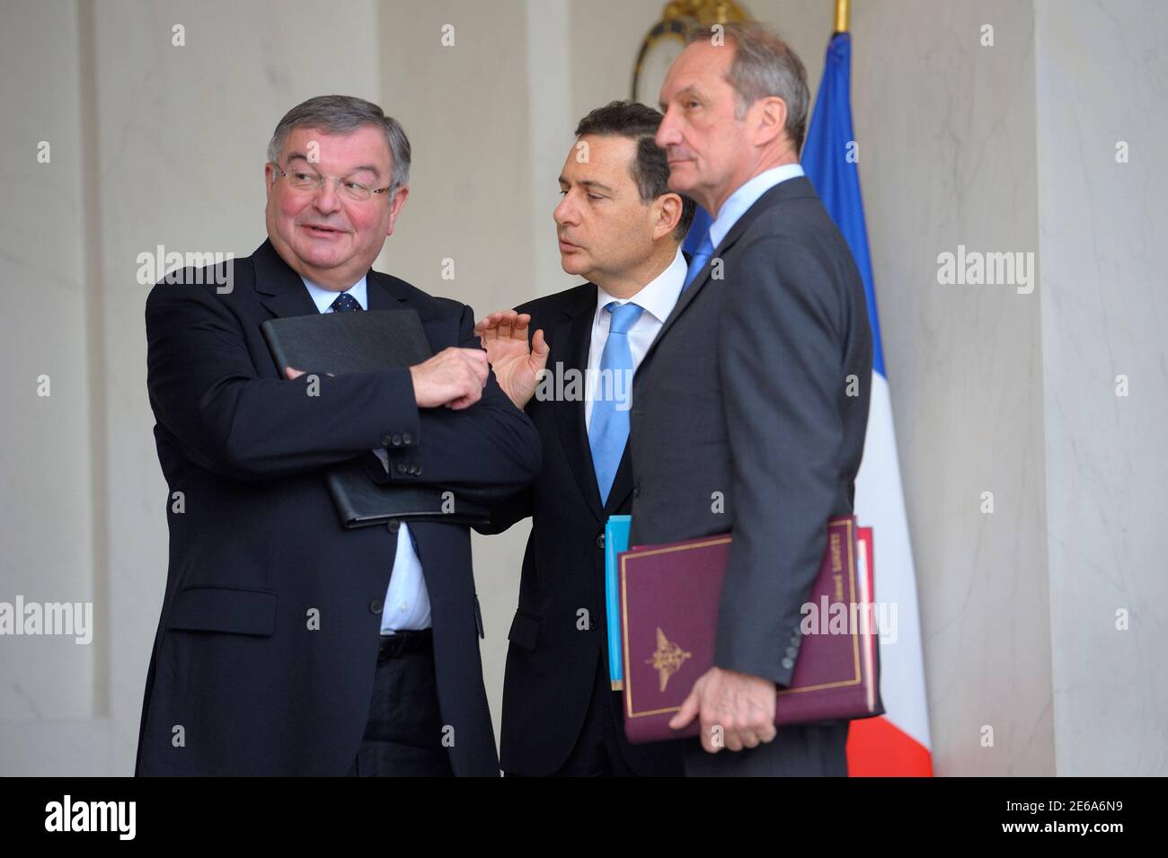 France's Defence Minister Gerard Longuet (R) speaks with Energy and  Industry Minister Eric Besson (C) and Justice Minister Michel Mercier (L)  as they leaves the Elysee Palace in Paris following the weekly