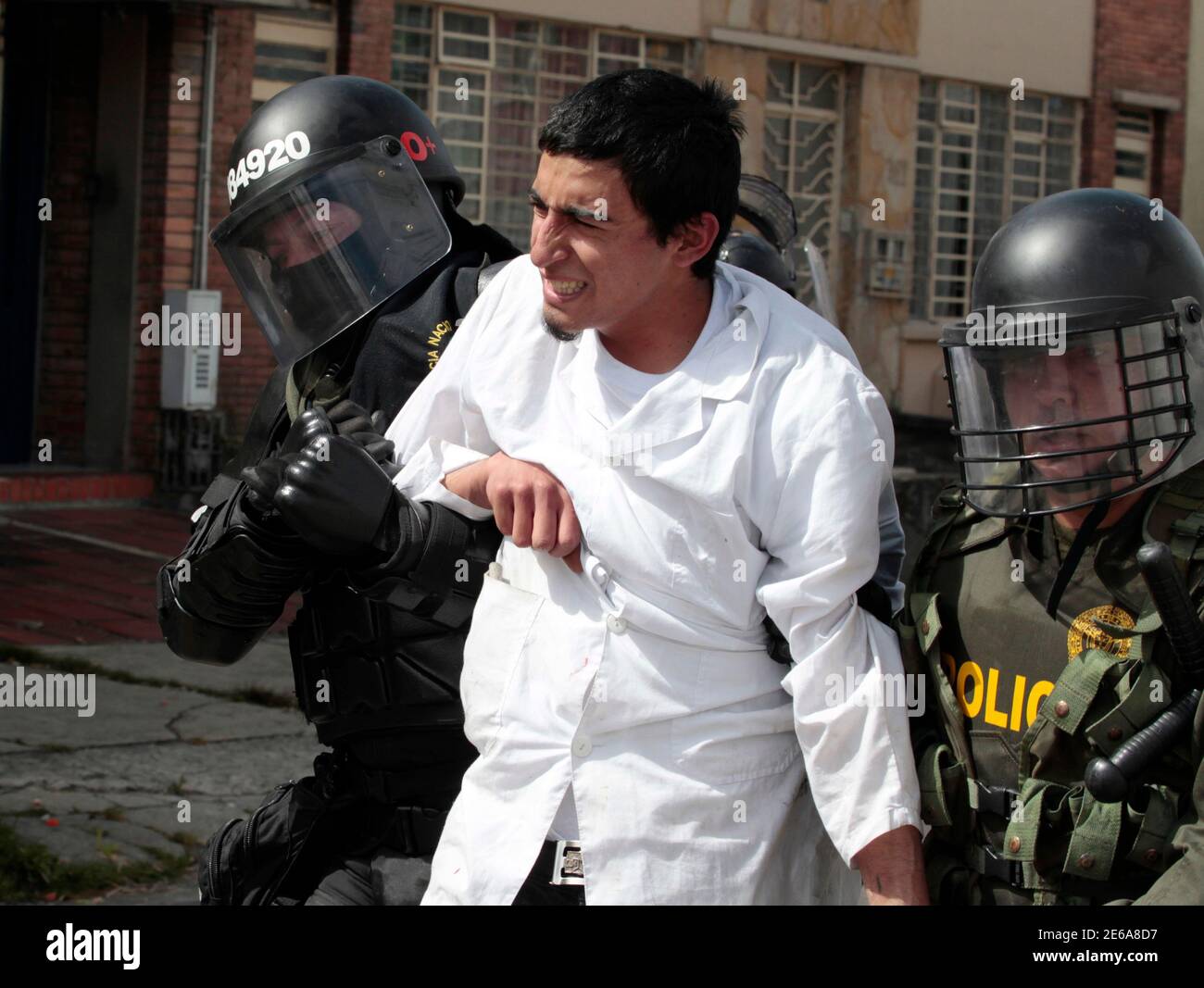 Riot police detain a student demonstrator during heavy protests in Bogota August 22, 2013. Thousands of demonstrators took part in protests in the country to demonstrate against the government, and to back a strike by farmers who are demanding for financial support from the government. REUTERS/Jose Miguel Gomez (COLOMBIA - Tags: CIVIL UNREST POLITICS) Stock Photo