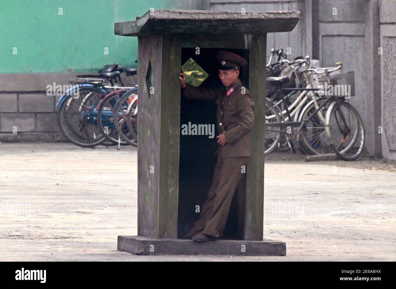 A North Korean soldier stands inside a sentry post along the bank of the Yalu River, near the North Korean town of Sinuiju, opposite the Chinese border city of Dandong, September 20, 2013. REUTERS/Jacky Chen (NORTH KOREA - Tags: MILITARY) Stock Photo