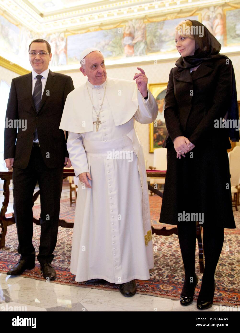 Pope Francis gestures during a private audience with Prime Minister of  Romania Victor Ponta (L) and his wife Daciana Sarbu at the Vatican March 1,  2014. REUTERS/Alessandra Tarantino/Pool (VATICAN - Tags: RELIGION