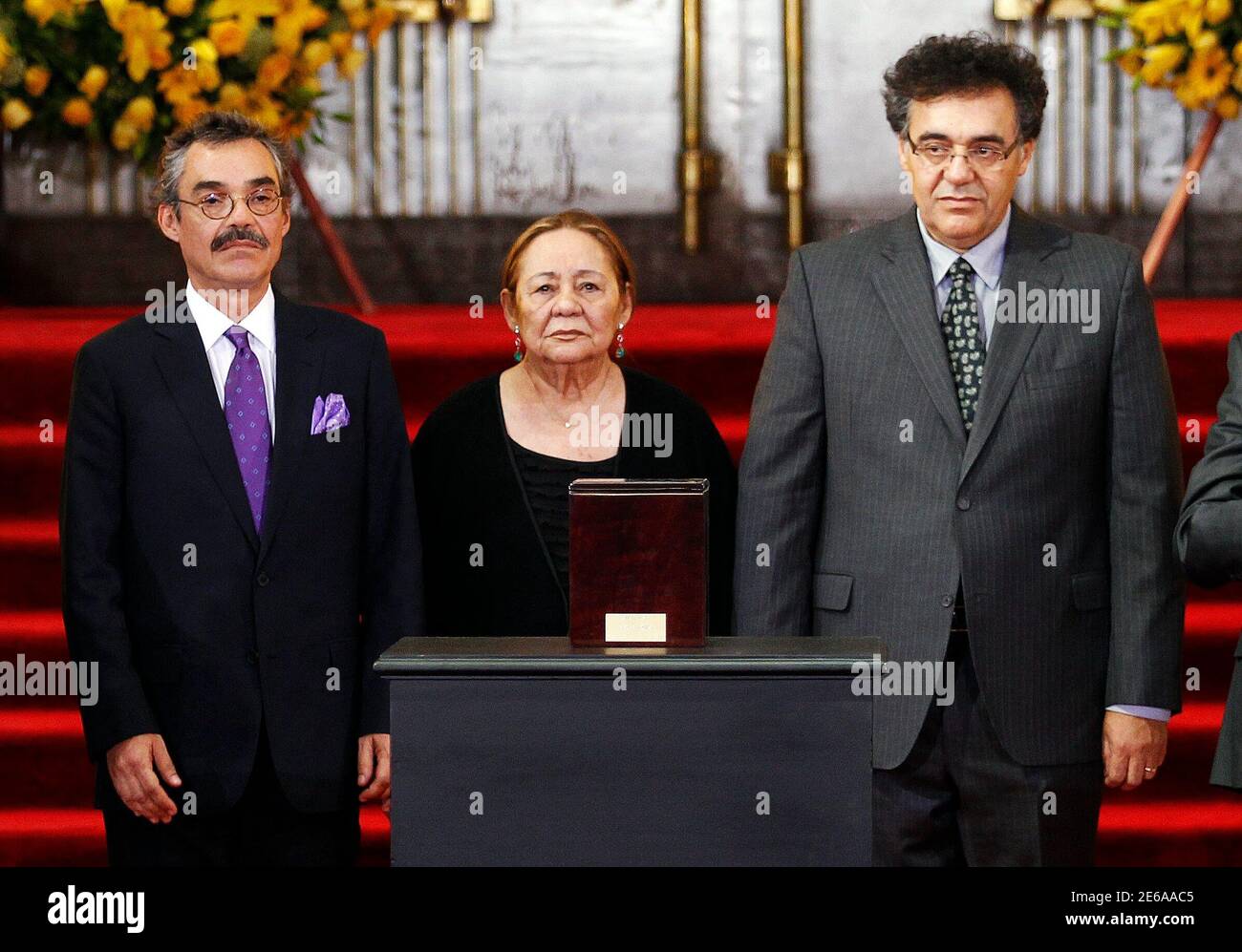 The family of Colombian Nobel laureate Gabriel Garcia Marquez, (L-R) son  Gonzalo Garcia Barcha, wife Marcedes Barcha, and son Rodrigo Garcia Barcha,  stand in front of the urn containing his ashes for