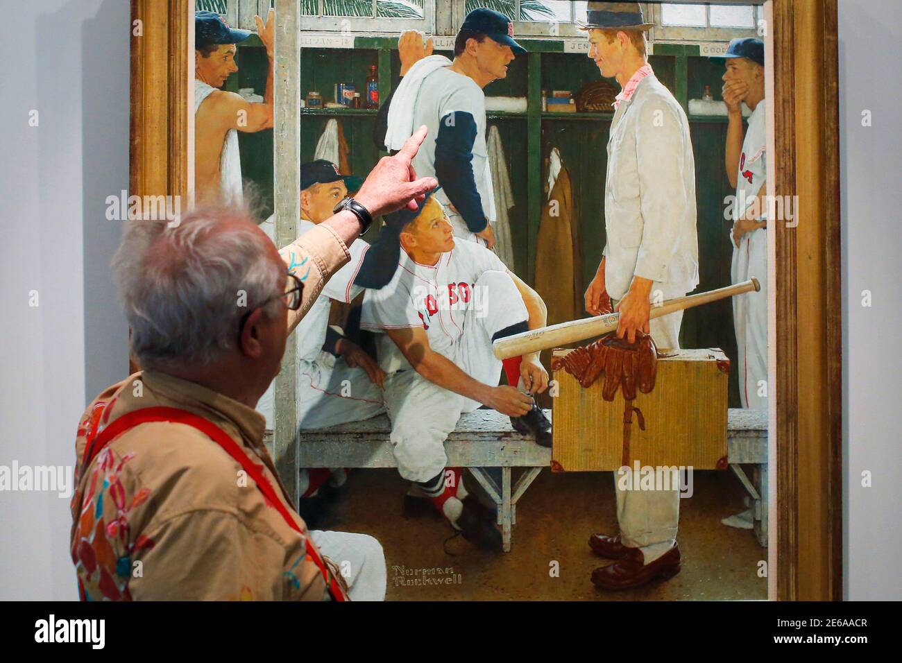 Peter Rockwell, son of painter Norman Rockwell, points to his father's 1957 painting 'The Rookie (Red Sox Locker Room)' on display at the Museum of Fine Arts, Boston for six days in Boston, Massachusetts April 29, 2014, before being offered at auction at Christie's May 22.  The painting, which appeared on the cover of the March 2, 1957 'Saturday Evening Post,' includes former Boston Red Sox players Ted Williams (top center), Jackie Jensen (bottom center) and Bill Goodman (R) as well as local high school student Sherman Safford who Rockwell asked to pose as the Rookie. Christies estimates the v Stock Photo