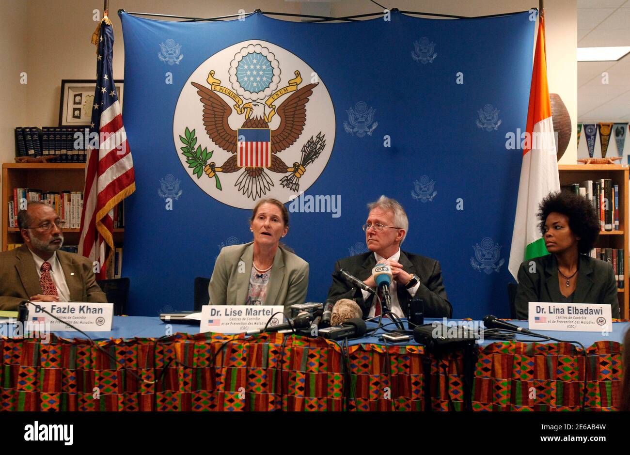Dr. Lise Martel (2nd L), a member of a U.S. experts delegation, speaks as she sits next to Terence Patrick McCulley, the U.S. ambassador to Ivory Coast, during a news conference aimed at helping to prevent the spread of the Ebola virus at the U.S. embassy in Abidjan September 18, 2014. Dr. Fazle Khan (L) and Dr. Lina Elbadawi (R), both of the U.S. Centers for the Control and Prevention of Diseases (CDC), sit on either side.     REUTERS/Luc Gnago   (IVORY COAST - Tags: HEALTH DISASTER POLITICS) Stock Photo