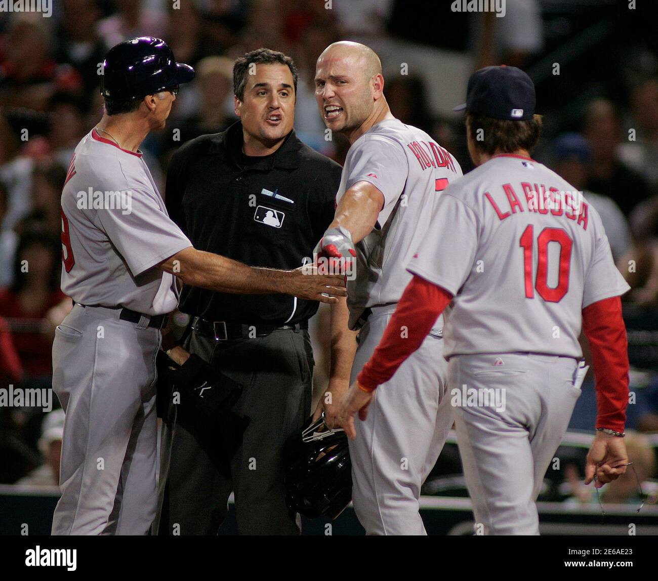 St. Louis Cardinals batter Matt Holliday (2nd R) argues with homeplate umpire Mike DiMuro (2nd L) along with Cards coach Dave McKay (L) after being ejected from the game for arguing his strikeout in the fourth inning of National League MLB baseball action in Atlanta, Georgia, September 9, 2010.  Approaching at right is Cardinals manager Tony LaRussa.  REUTERS/Tami Chappell (UNITED STATES - Tags: SPORT BASEBALL) Stock Photo