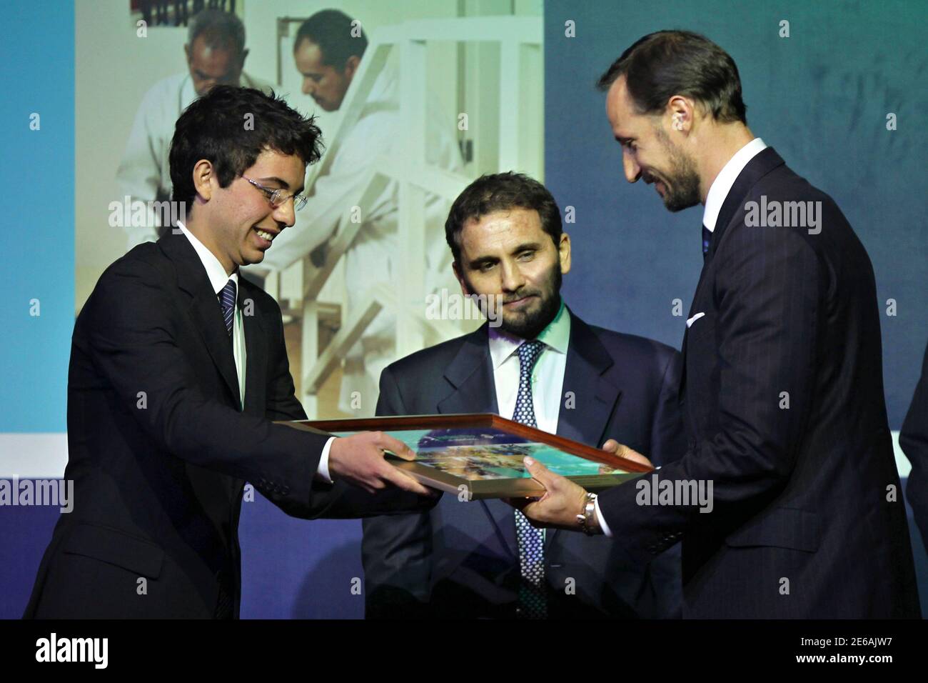 Jordan's Crown Prince Hussein bin (L) presents a token of to Norway's Prince Haakon for his support in by the Jordan Free of Minefields at its event at