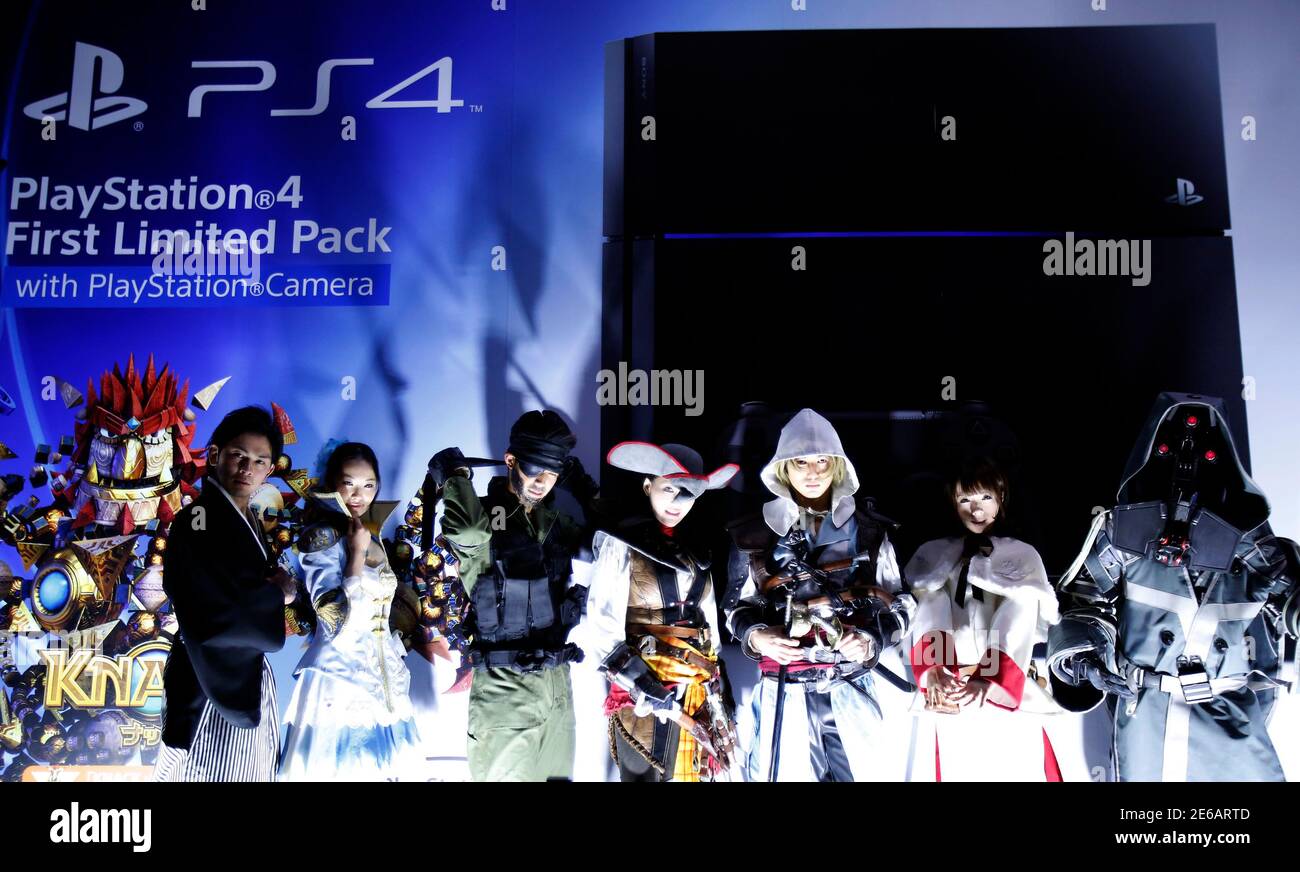 People Wearing Costumes Of Playstation S Game Characters Pose In Front Of An Advertisement Board For Playstation 4 Game Consoles Before Its Domestic Launch Event Outside The Sony Showroom In Tokyo February 21