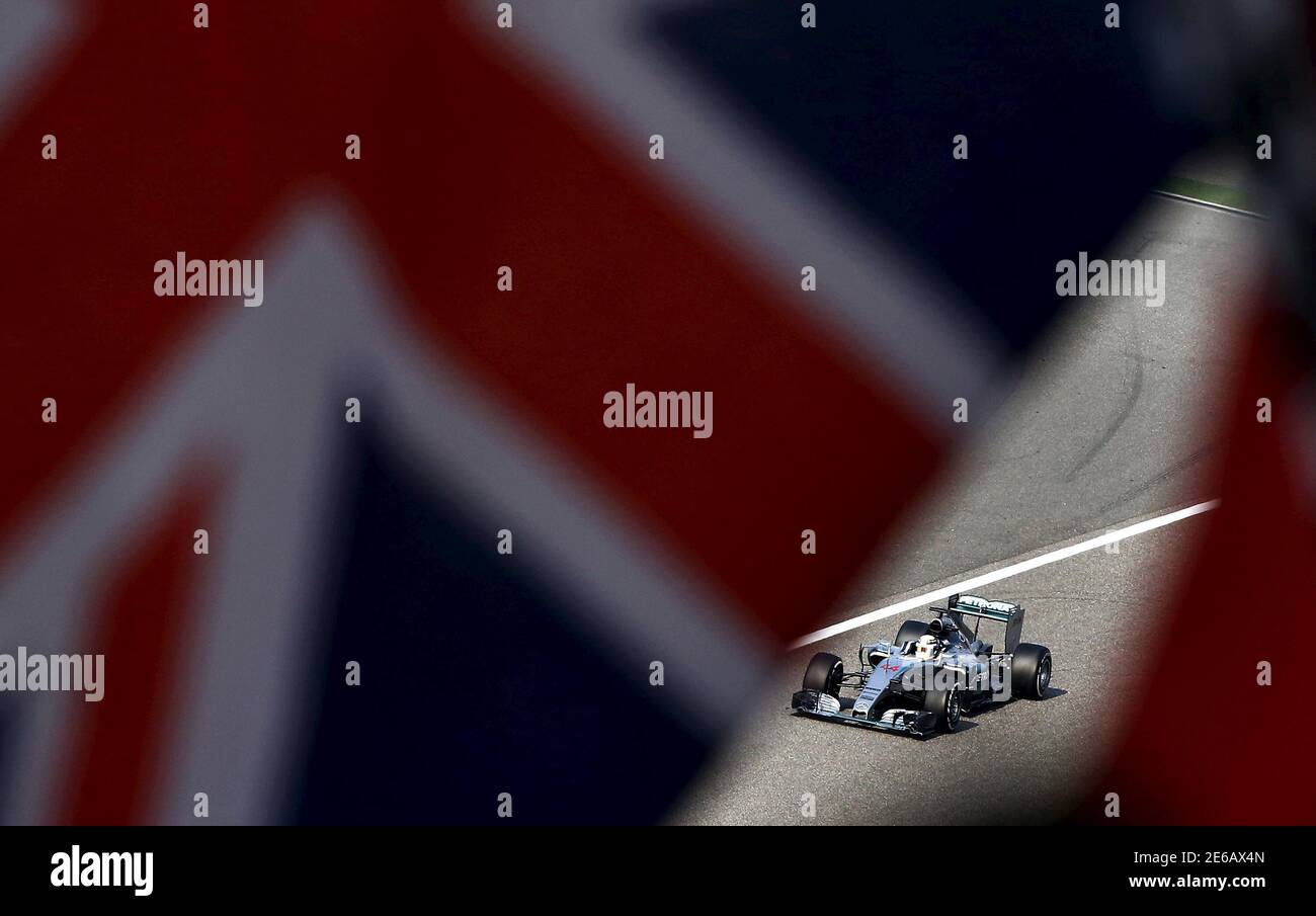 Mercedes Formula One driver Lewis Hamilton of Britain is seen behind British national flags in the last lap  of the Chinese F1 Grand Prix at the Shanghai International Circuit, April 12, 2015. REUTERS/Carlos Barria Stock Photo