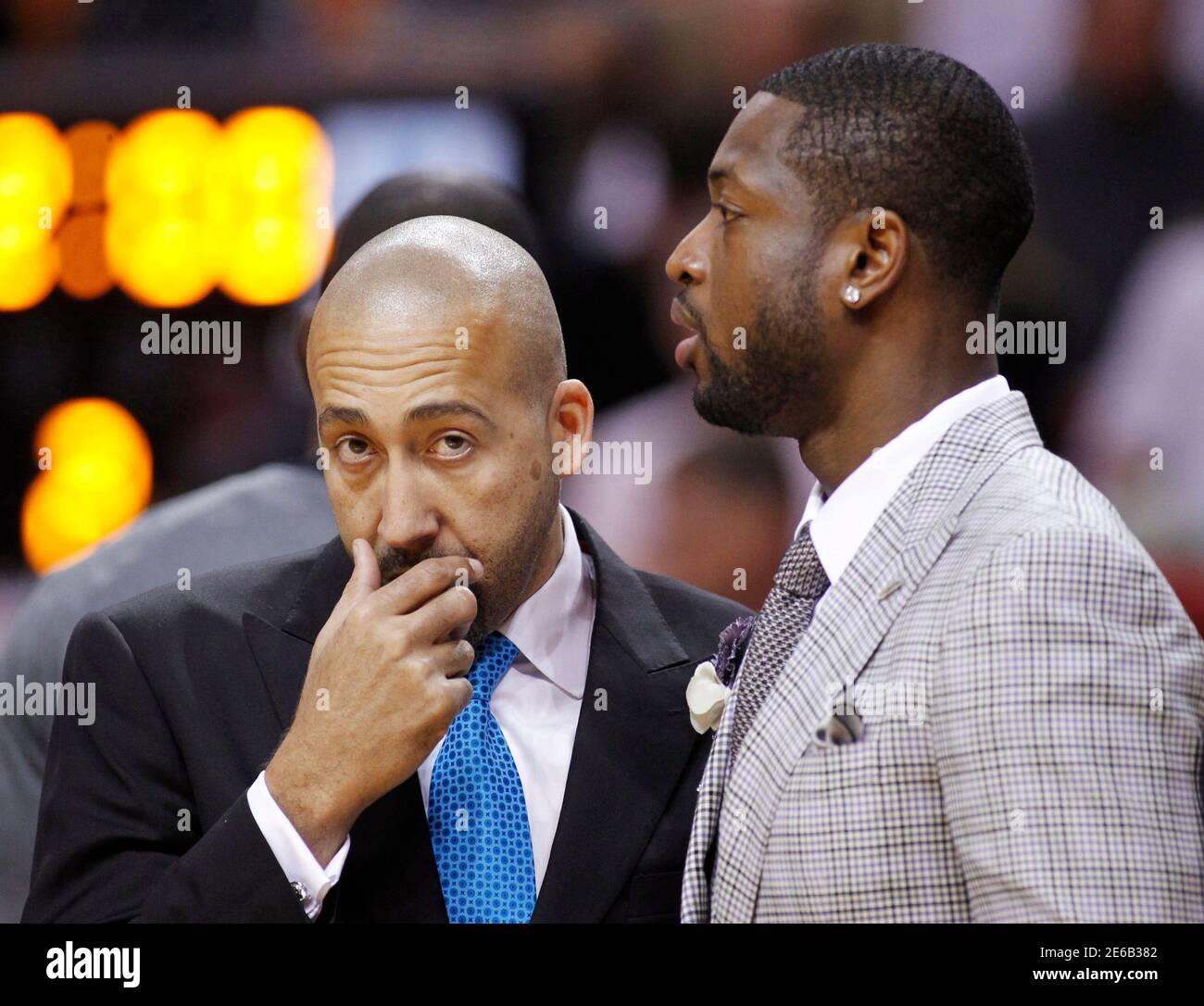 Miami Heat's Dwyane Wade (R) who is injured, speaks with Heat assistant  coach David Fizdale during a time-out as the Heat faced the Cleveland  Cavaliers in their NBA basketball game in Miami,