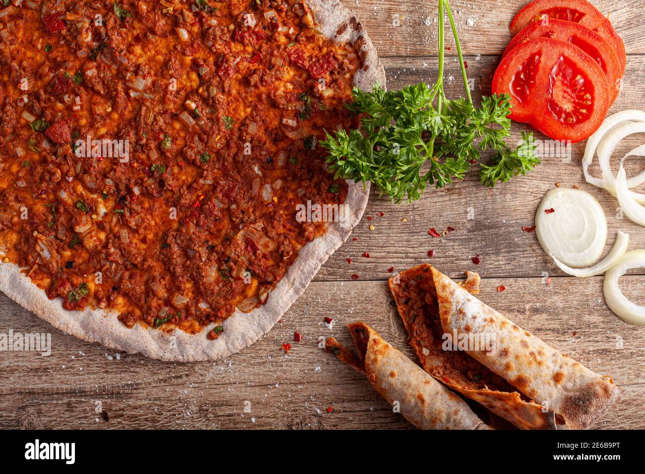 Traditional Turkish Pizza known as Lahmacun made with thin flat dough covered with mixture containing ground beef and baked in stone oven. It is serve Stock Photo