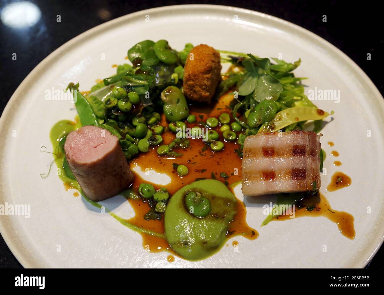 A plate of Hungarian "mangalica" pork prepared in three ways by a chef at Costes, the first restaurant to earn a Michelin star in Hungary, is seen in Budapest, Hungary, June 9, 2015. Mangalicas, which were all but extinct 25 years ago, now feature prominently in some of the best restaurants in the world for their meat, which gets its exceptional taste from the fat stored inside the muscle tissue. Picture taken June 9, 2015. REUTERS/Laszlo Balogh Stock Photo