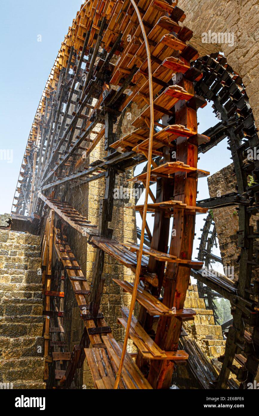 Historic water wheels called as Norias in the Syrian city of Hama. Wooden turbines pull water from the low bed of orontes river and divert it to canal Stock Photo