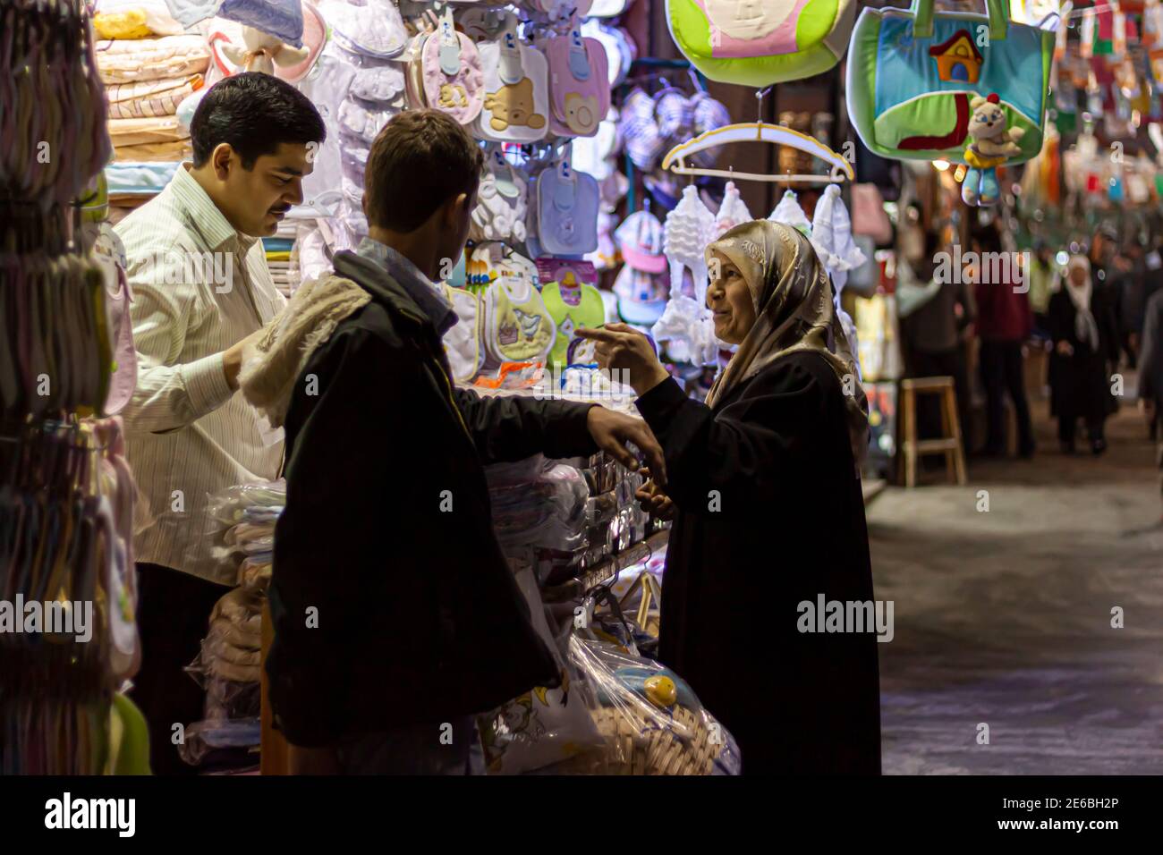 Damascus, Syria 03-28-2010: An Arabic woman wearing hijab is shopping at an apparel and baby clothing store in the historic Al Hamidiyah Souq. She is Stock Photo