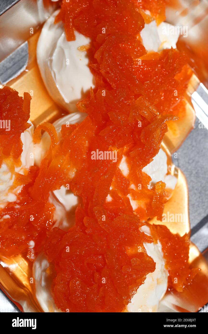 Greek yogurt dessert with sweet carrot in aluminum box to go take away macro background modern
