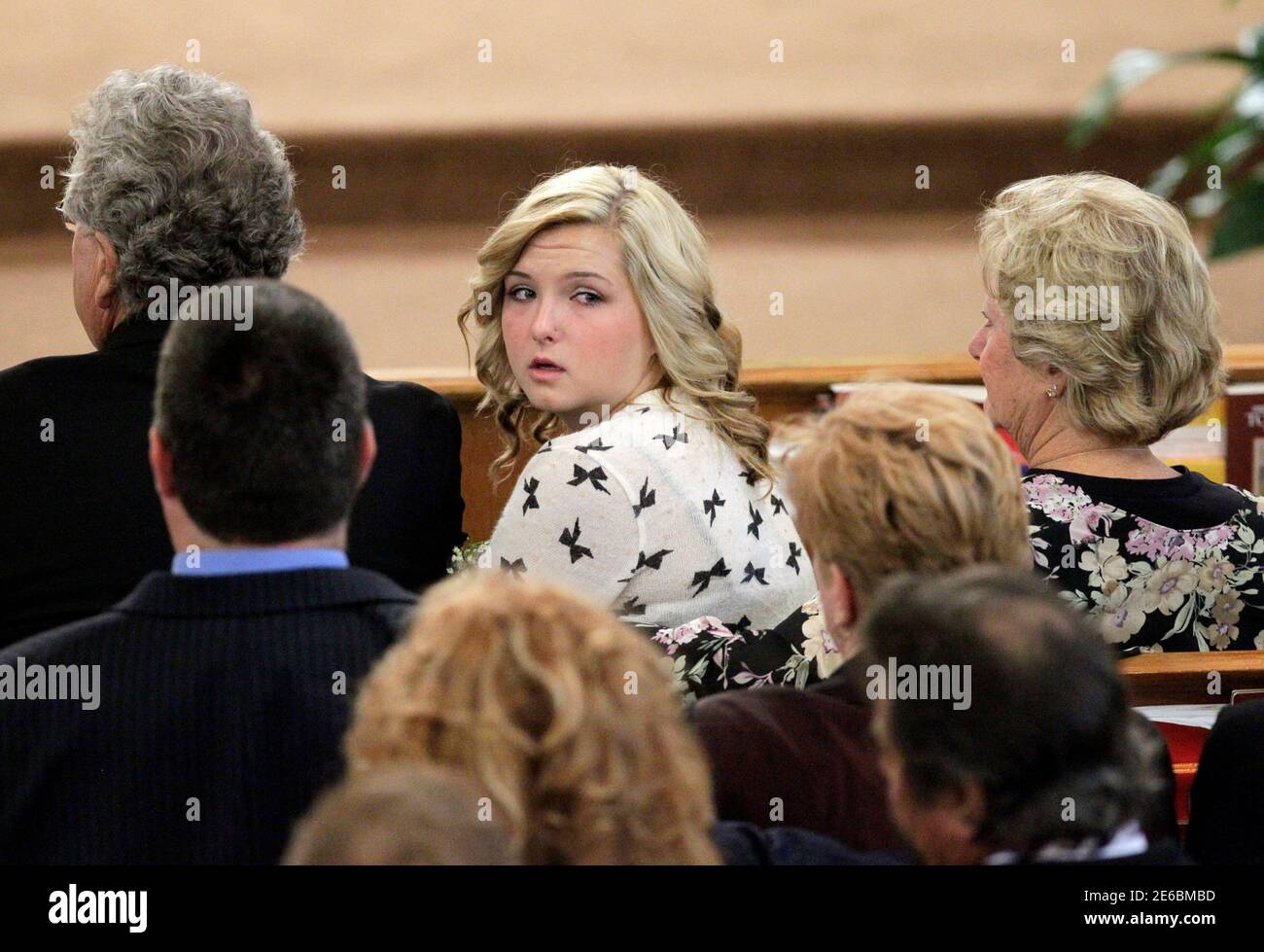 Kidnap victim Hannah Anderson (C) sits with her grand parents Ralph and  Sara Britt as they attend a memorial service for her mother Christina  Anderson, 44, and her 8-year-old brother Ethan at