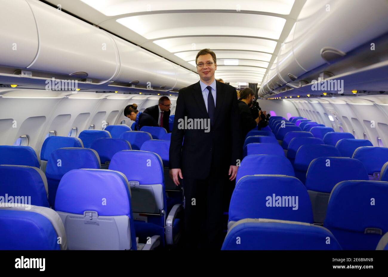 Serbia's Deputy Prime Minister Aleksandar Vucic walks inside a new Airbus 319 plane in Belgrade October 25, 2013. From animal feed to missiles and loans, Serbia is banking on an unlikely alliance with the United Arab Emirates to upgrade its vital farming industry, revive military production and get badly needed cheaper finance. The first deal was a $40 million equity investment by Abu Dhabi's Etihad airline in Serbia's indebted JAT Airways. Picture taken October 25, 2013. REUTERS/Marko Djurica (SERBIA - Tags: BUSINESS TRANSPORT POLITICS) Stock Photo