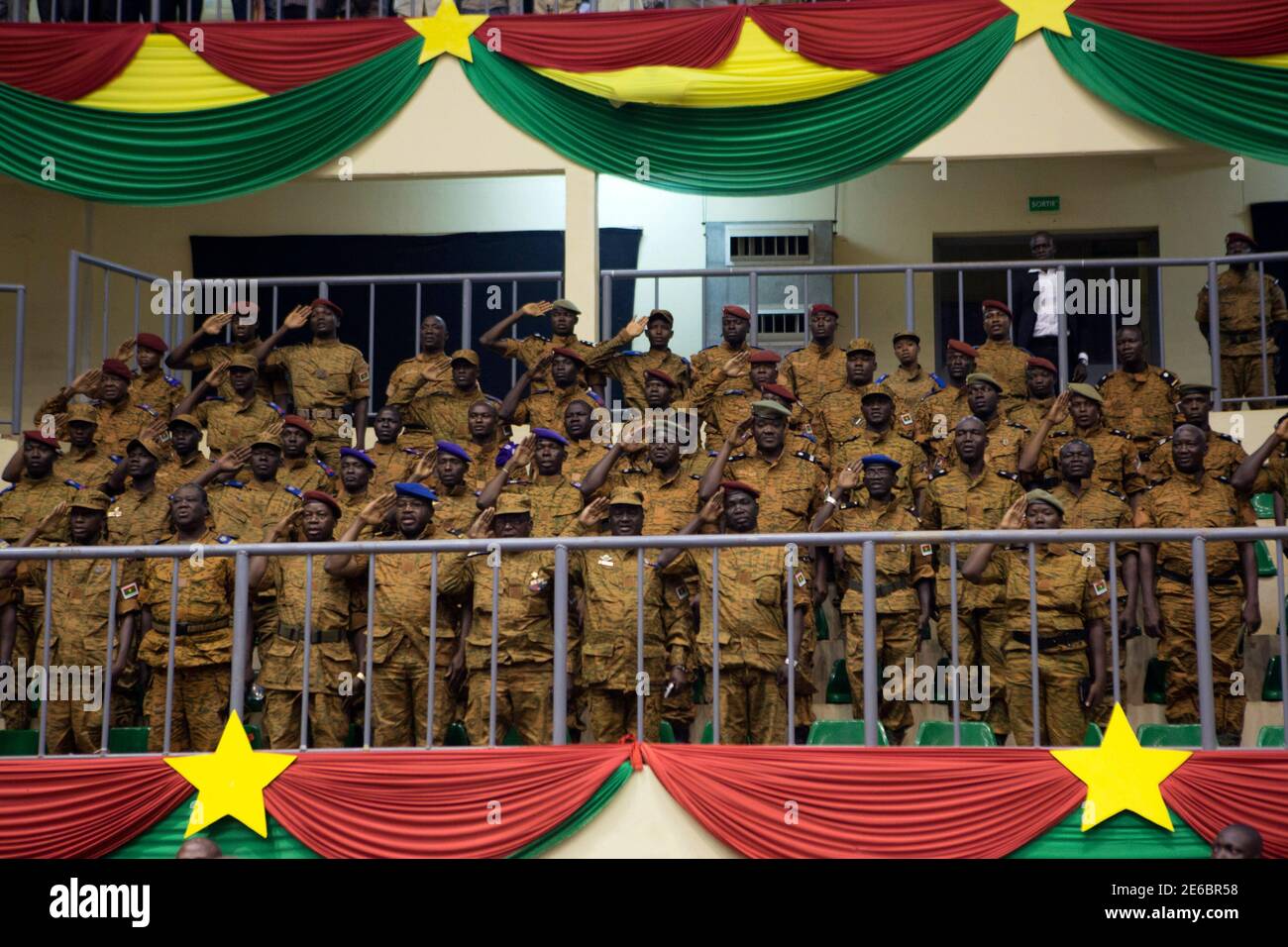 Soldiers salute during the swearing-in ceremony of Burkina Faso's President Michel Kafondo in Ouagadougou November 21, 2014. Kafando was chosen by a committee on Monday set up after former president Blaise Compaore resigned and fled on October 31 in the face of mass protests against his attempt to change the constitution and extend his 27-year rule. Kafondo, who was sworn into his post for the transitional period of one year, is faced with the task of leading the West African country to elections in a year following a brief military takeover.    REUTERS/Joe Penney (BURKINA FASO - Tags: POLITIC Stock Photo