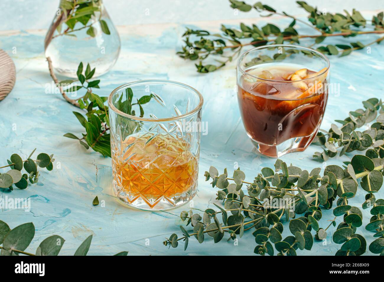 Two glasses of different alcoholic drinks on blue Stock Photo
