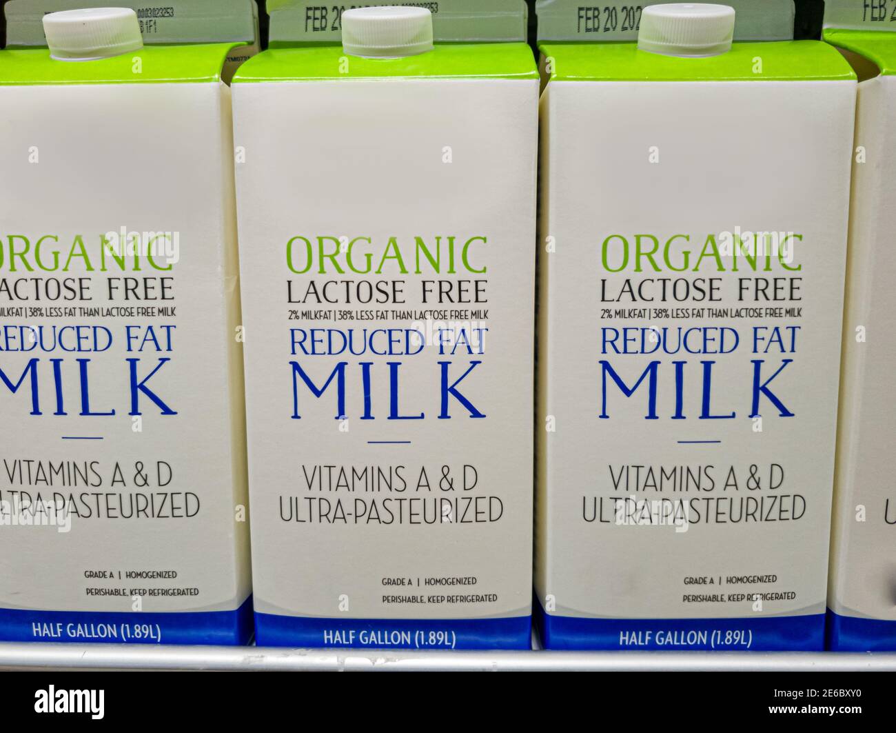 Half gallon cartons of lactose free reduced fat organic milk on fridge shelf. This is for people who are lactose intolerant due to enzymatic deficienc Stock Photo