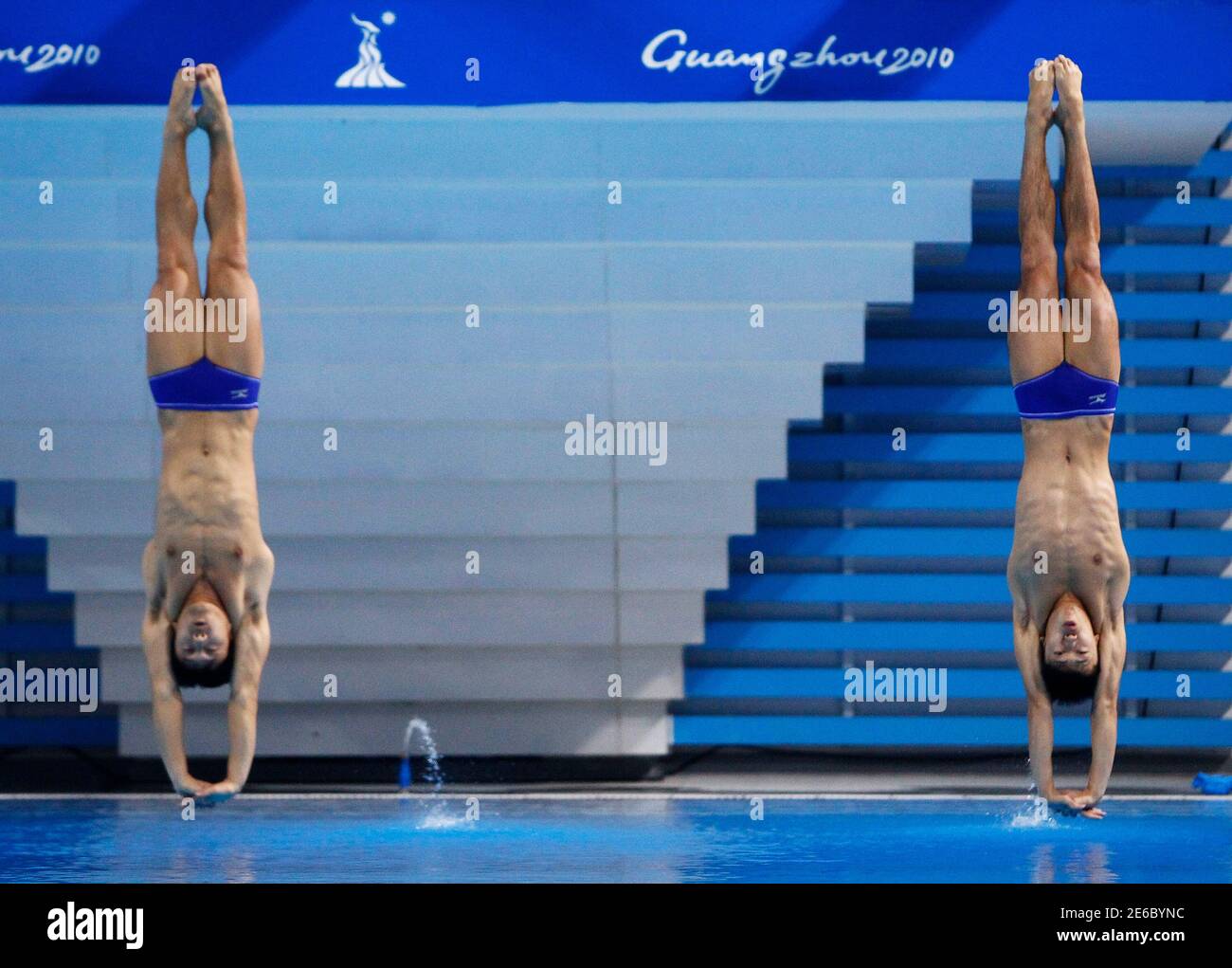 Yu Okamoto and Sho Sakai of Japan compete in the men's synchronized 3m springboard diving event at the 16th Asian Games in Guangzhou, Guangdong province, November 23, 2010. REUTERS/Jason Lee (CHINA  - Tags: SPORT DIVING) Stock Photo