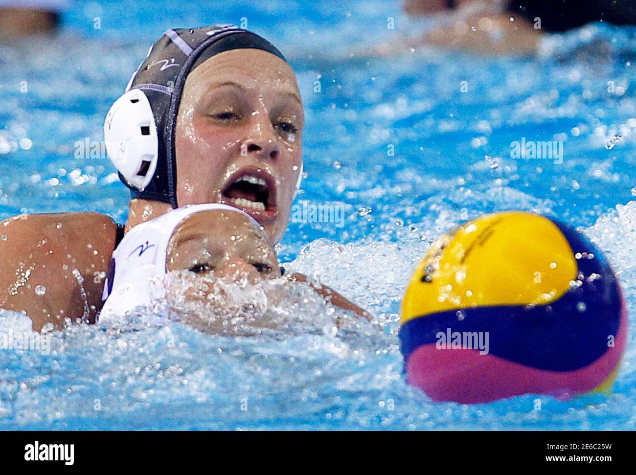 New Zealand's Ashley Elizabeth Smallfield (back) and Nomi Lisa Stomphorst of the Netherlands fight for possession of the ball during their women's water polo quarter-final qualification match at the 14th FINA World Championships in Shanghai July 23, 2011. REUTERS/David Gray (CHINA  - Tags: SPORT WATER POLO AQUATICS) Stock Photo