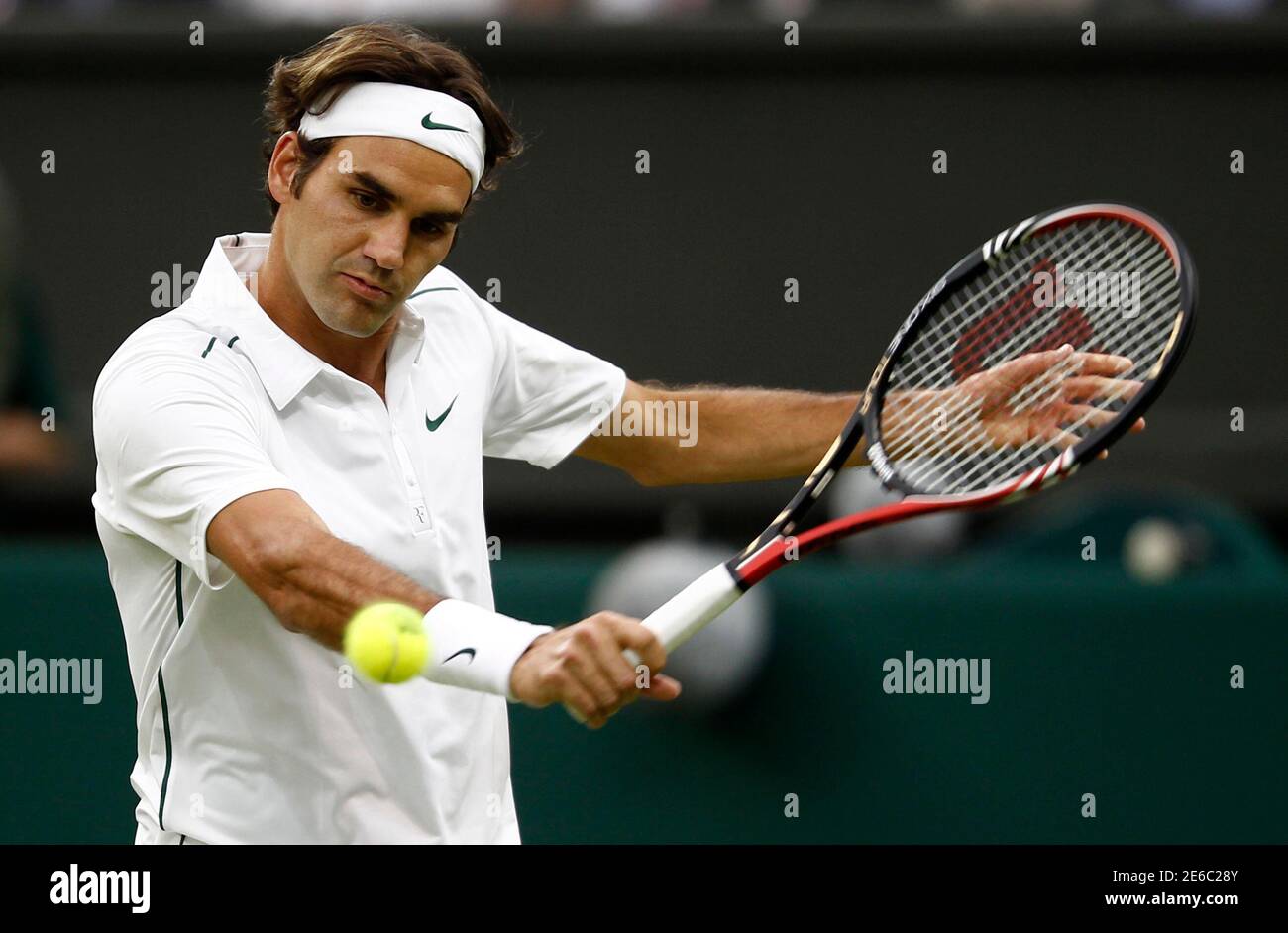 Roger Federer of Switzerland hits a return to Adrian Mannarino of France at  the Wimbledon tennis championships in London June 23, 2011. REUTERS/Eddie  Keogh (BRITAIN - Tags: SPORT TENNIS Stock Photo - Alamy