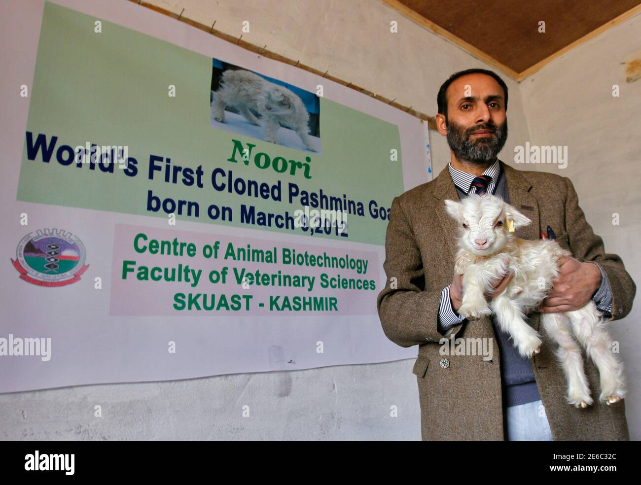 Dr Riaz Ahmad Shah holds Noori, a cloned Pashmina goat, at the Faculty of  Veterinary Sciences and Animal Husbandry of Sher-e-Kashmir University of  Agricultural Sciences and Technology (SKUAST), in Shuhama, 25 km (