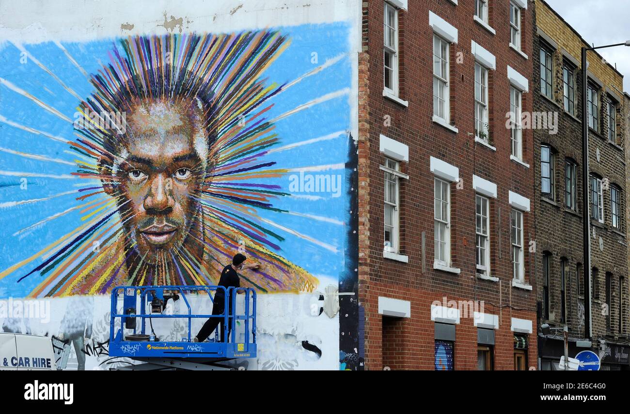 Street artist James Cochran, also known as Jimmy C, works on his spray painted picture of Jamaican sprinter Usain Bolt in Sclater street car park in east London July 19, 2012. Cochran said this was done as an homage to the London 2012 Olympic Games, which begin July 27. REUTERS/Paul Hackett  (BRITAIN - Tags: SPORT OLYMPICS ATHLETICS ENTERTAINMENT) Stock Photo