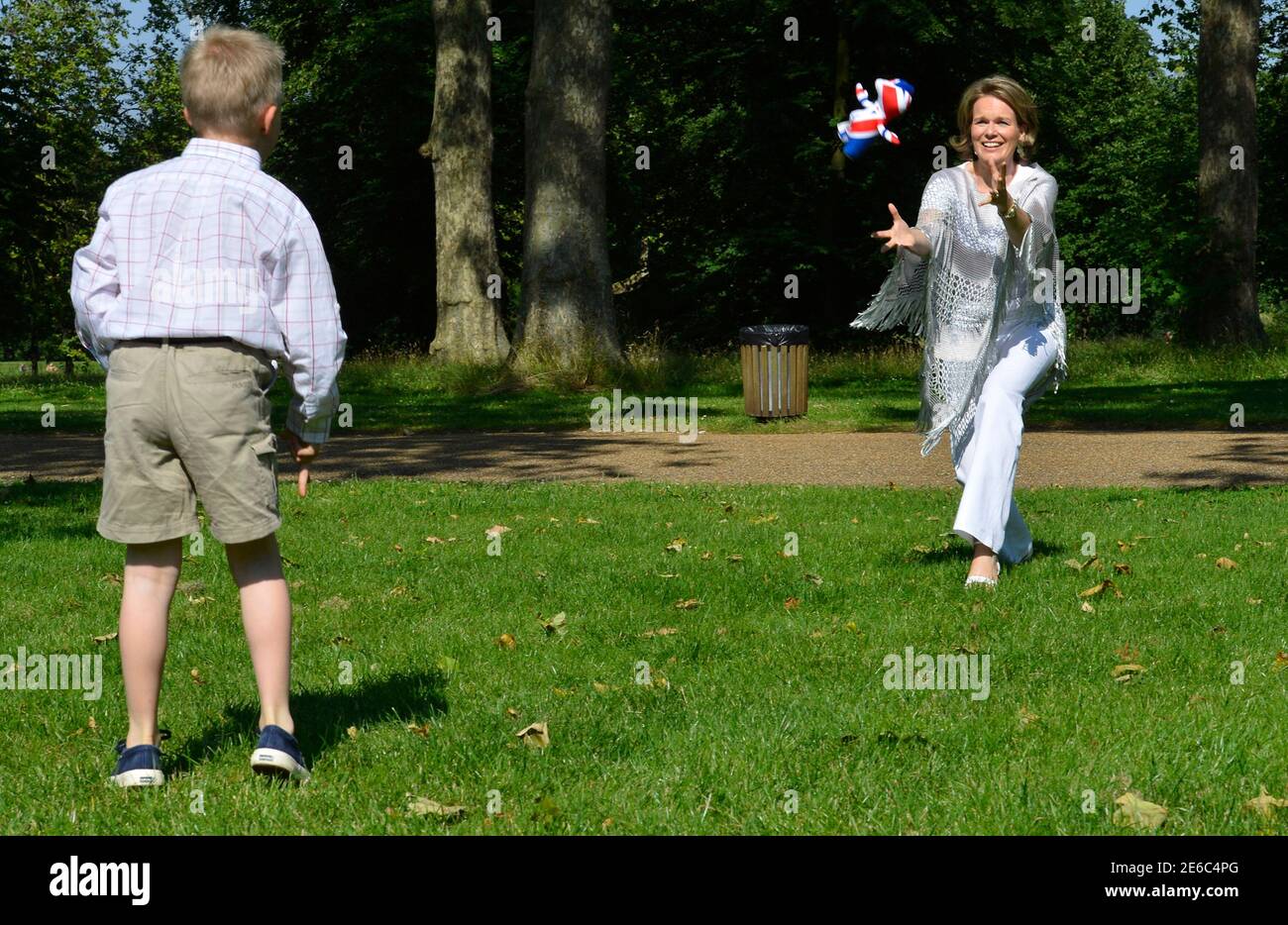 Belgium's Crown Princess Mathilde (R) and Prince Emmanuel (L) play in a park while visiting central London ahead of the London 2012 Olympic Games July 26, 2012. Picture taken on July 26, 2012.                    REUTERS/Benoit Doppagne/Pool   (BRITAIN  - Tags: SPORT ROYALS POLITICS SPORT OLYMPICS) Stock Photo
