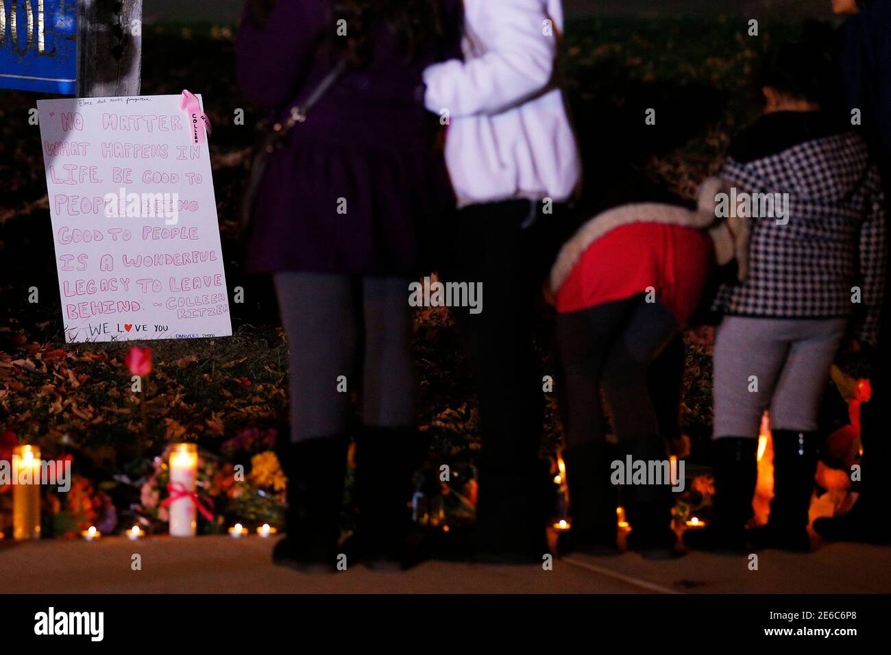 People gather at a makeshift memorial for teacher Colleen Ritzer outside  the high school where she taught in Danvers, Massachusetts October 23,  2013. Massachusetts authorities on Wednesday charged 14-year-old high  school student