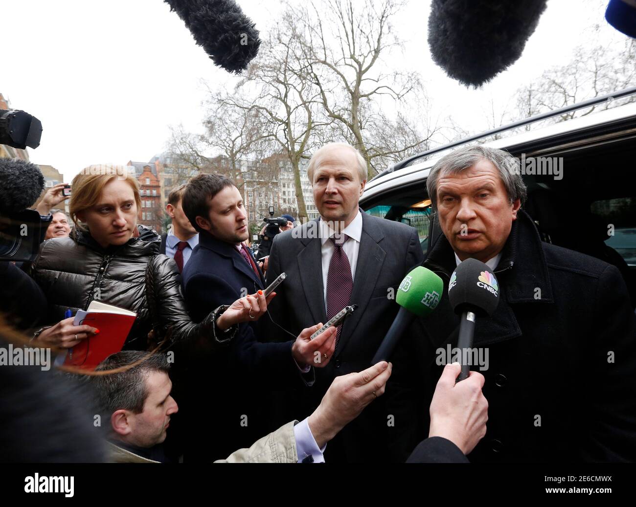 British Petroleum CEO Bob Dudley (C) and Rosneft CEO Igor Sechin (R) speak to journalists as they arrive outside the BP headquarters in central London March 21, 2013. Russian state oil company Rosneft closed its deal to buy TNK-BP from UK-based BP and four tycoons on Thursday, releasing $40 billion cash to the sellers and becoming a bigger oil producer than Exxon Mobil. The $55 billion deal, which also gives BP a near 20 percent stake in Rosneft, was announced last year after months of on-off negotiations. It is the biggest in Russia's corporate history.. REUTERS/Olivia Harris (BRITAIN - Tags: Stock Photo