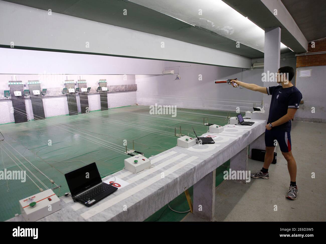 Italian pentathlon athlete Pier Paolo Petroni shoots during a training session at the shooting range in Montelibretti, outside Rome April 3, 2012. Laser guns will replace traditional air pistols in the modern pentathlon at the 2012 London Olympics.  REUTERS/Alessandro Bianchi (ITALY - Tags: SPORT OLYMPICS MODERN PENTATHLON) Stock Photo