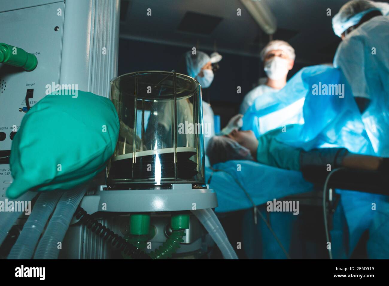 Respiratory ventilation apparatus close up and team of doctors onthe