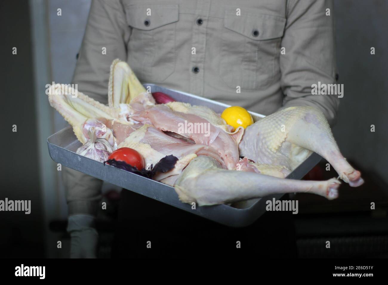 A butcher wrapping a piece of pork meat on a counter Stock Photo Alamy