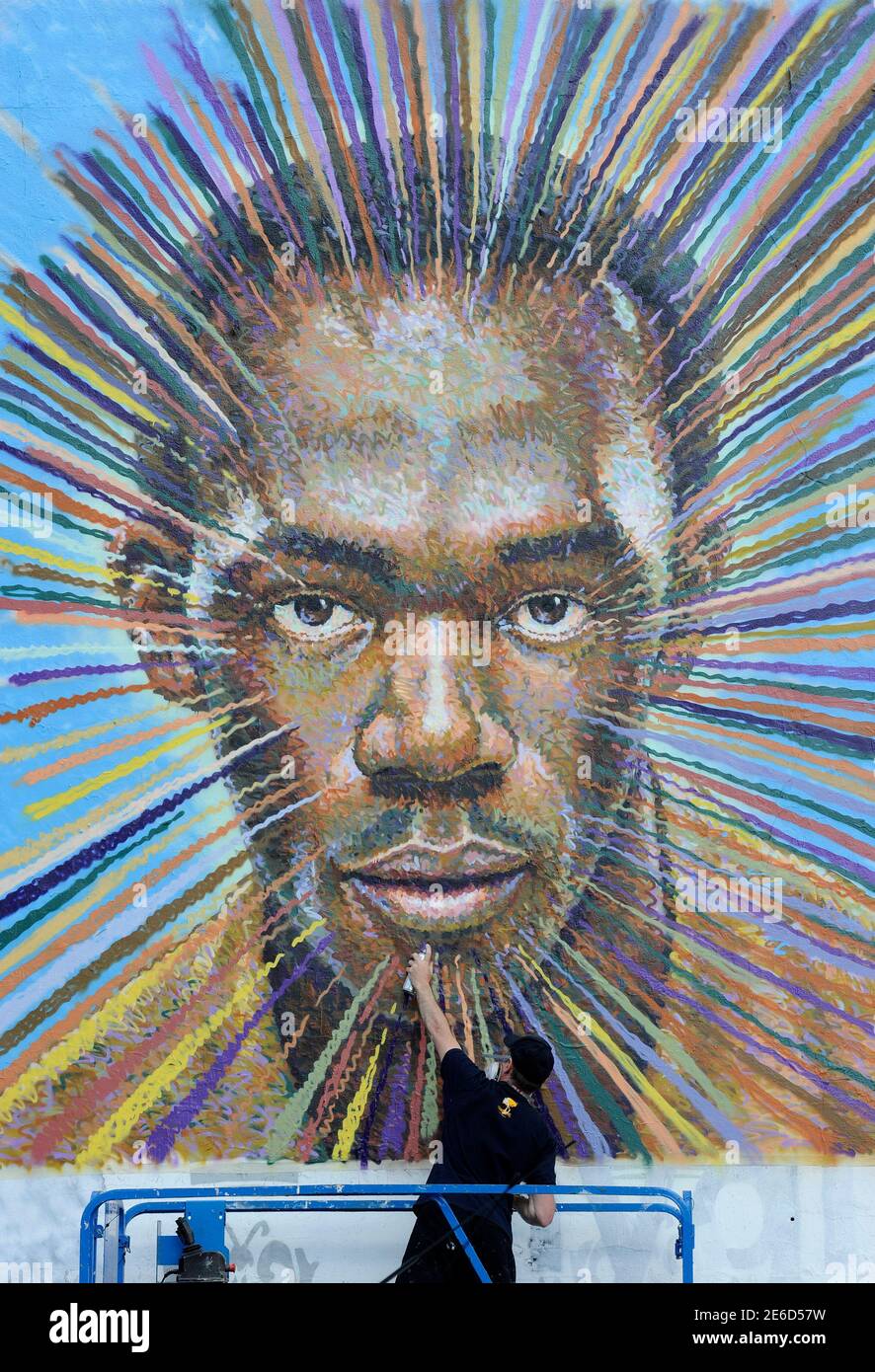 Street artist James Cochran, also known as Jimmy C, works on his spray painted picture of Jamaican sprinter Usain Bolt in Sclater street car park in east London July 19, 2012. Cochran said this was done as an homage to the London 2012 Olympic Games, which begin July 27. REUTERS/Paul Hackett  (BRITAIN - Tags: SPORT OLYMPICS ATHLETICS ENTERTAINMENT TPX IMAGES OF THE DAY) Stock Photo