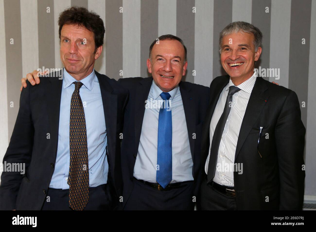 Pierre Gattaz (C), Chief executive of large, family-owned connectors  company Radiall, Omea Telecom Chief Executive Officer Geoffroy Roux de  Bezieux (L) and French businessman Patrick Bernasconi pose for the media  after a