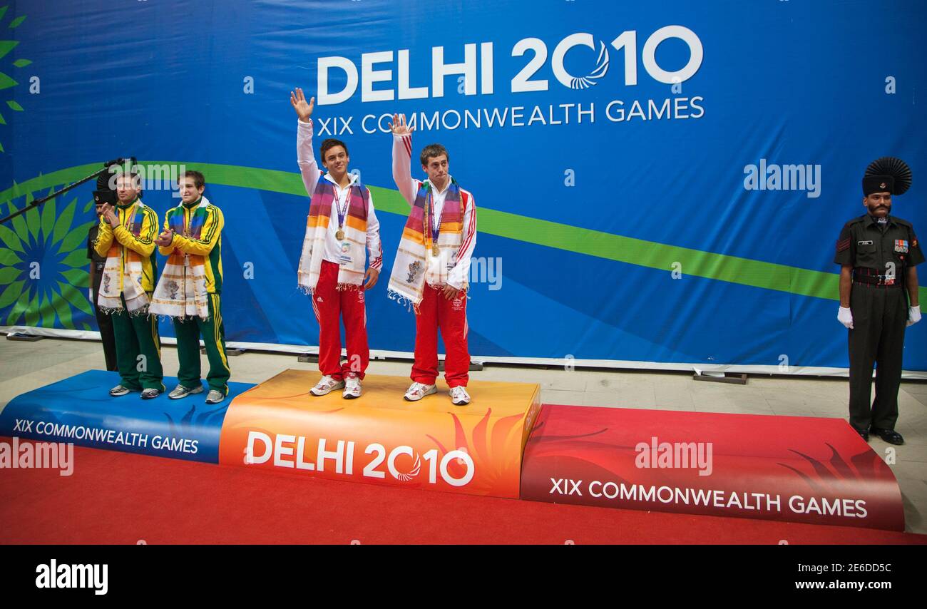 England's gold medallists Max Brick (3rd L) and Tom Daley (4th L) pose on the podium with Australia's silver medallists Matthew Mitcham (L) and Ethan Warren (2nd L), without third place winners, during the prize ceremony for the men's synchronised 10m platform diving final at the Commonwealth Games in New Delhi October 12, 2010. Although Canadian divers Eric Sehn and Kevin Geyson placed third, medals were not awarded because of a rule that requires a minimum of five teams to award bronze. Only four teams competed at the Commonwealth Games - England, Australia, Canada and Malaysia.  REUTERS/And Stock Photo