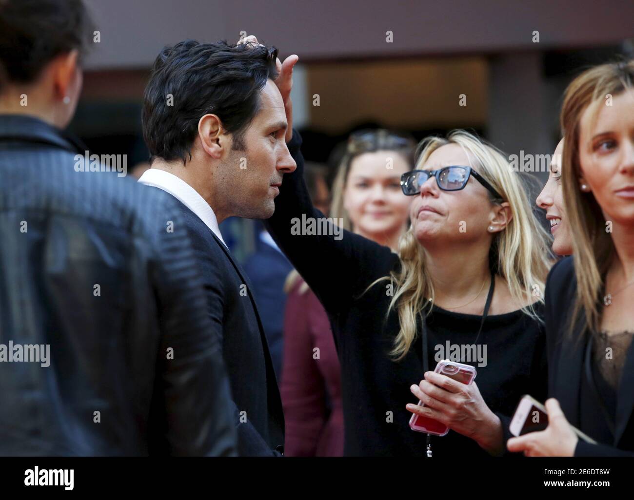 Actor Paul Rudd has someone adjust his hair as he arrives for the European  premiere of 